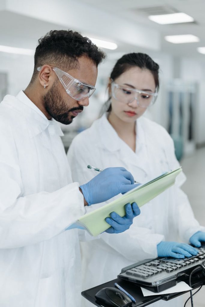 Two scientists working together in a laboratory, analyzing data and discussing results.